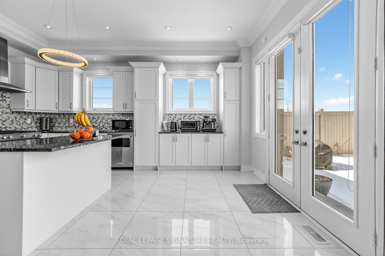 Chef's kitchen with island and walkout to backyard