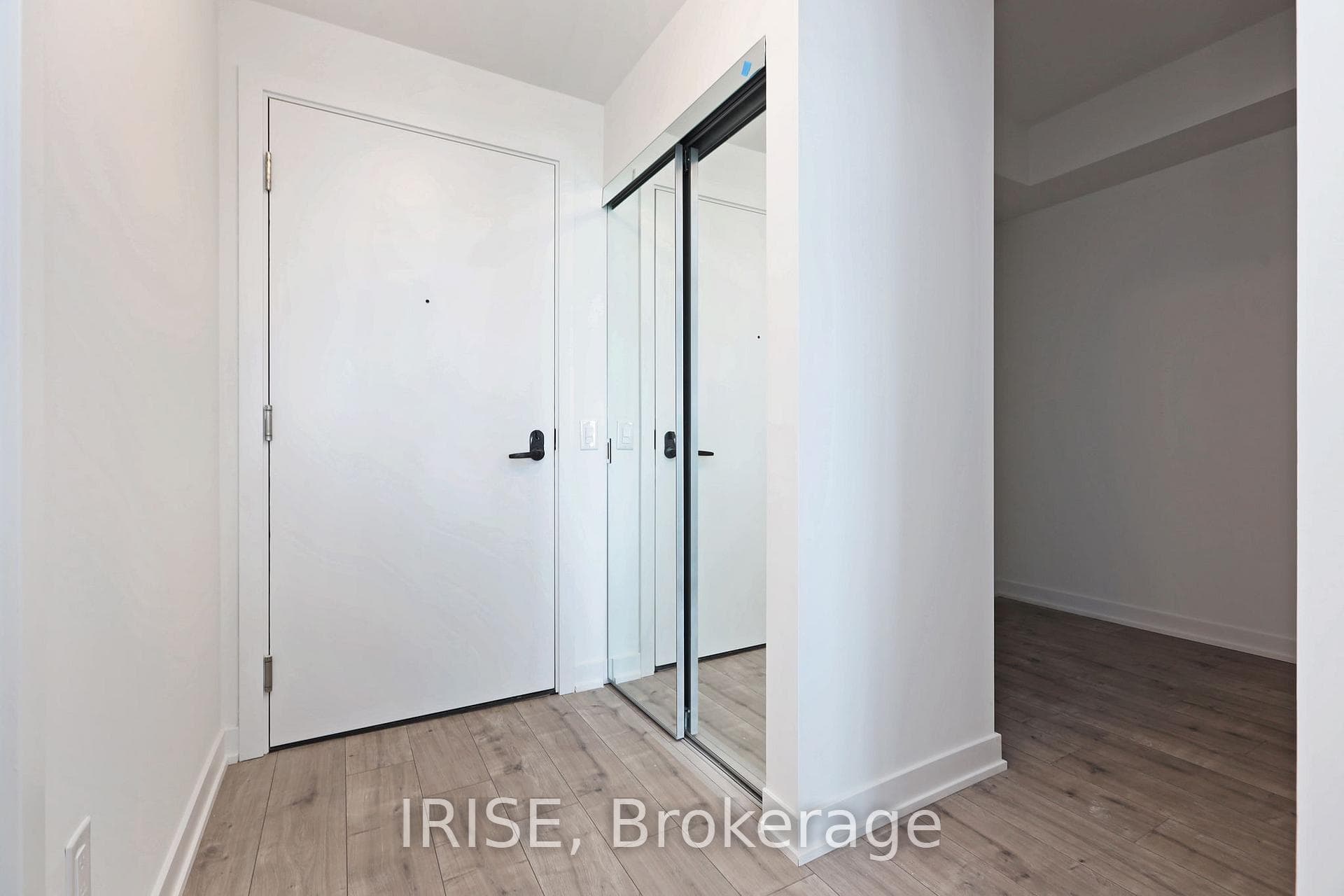 Bright entryway with mirrored closet doors