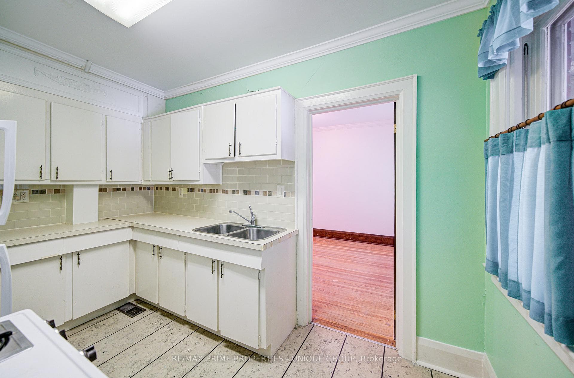 Main floor kitchen with doorway to dining room