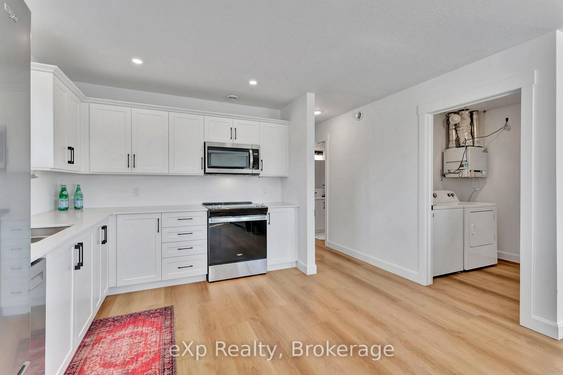 Kitchen in relation to laundry and bath
