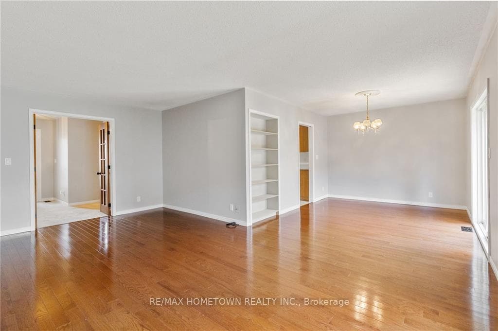 Open concept living and dining room with hardwood