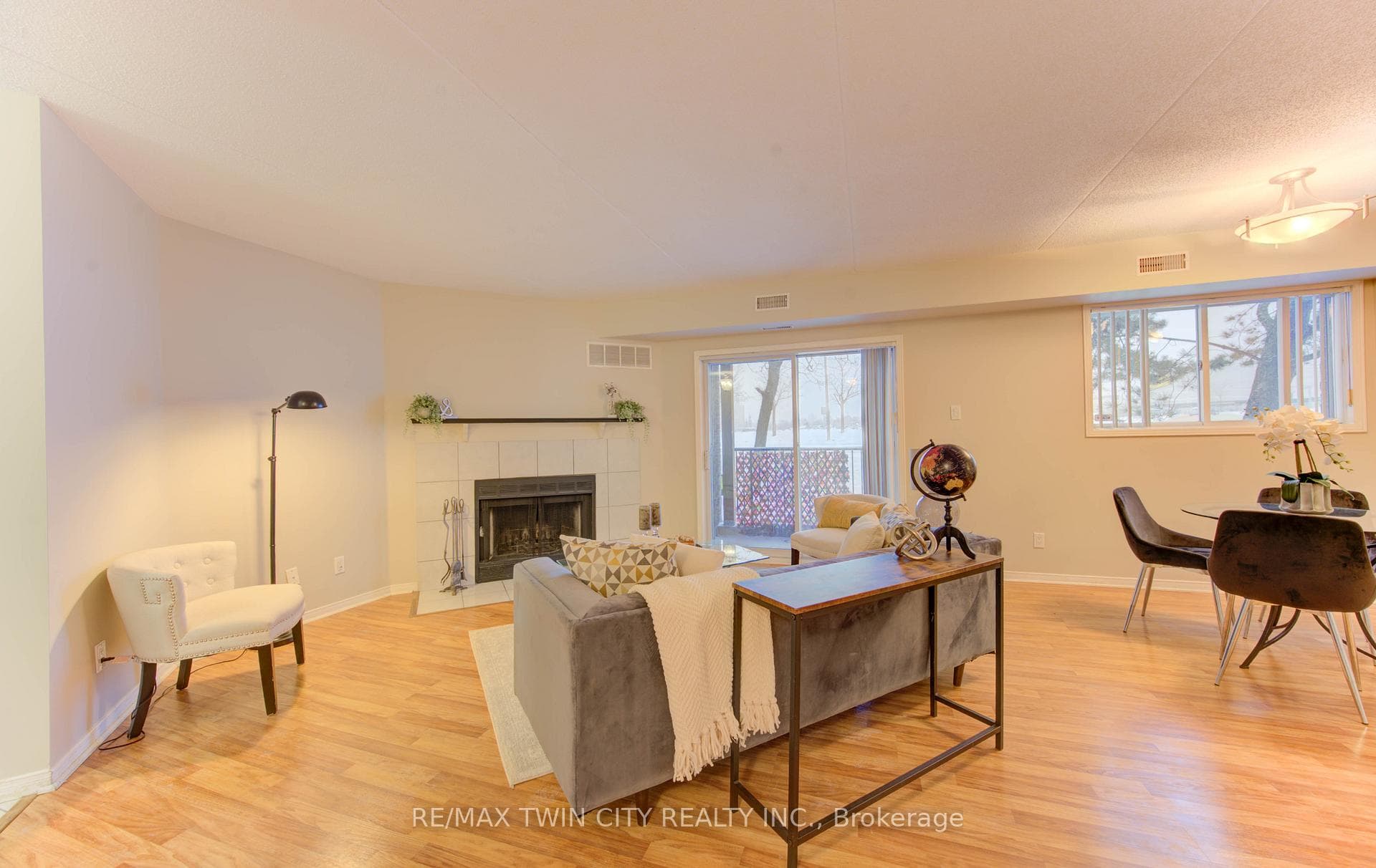 Living room with decorative fireplace and walkout