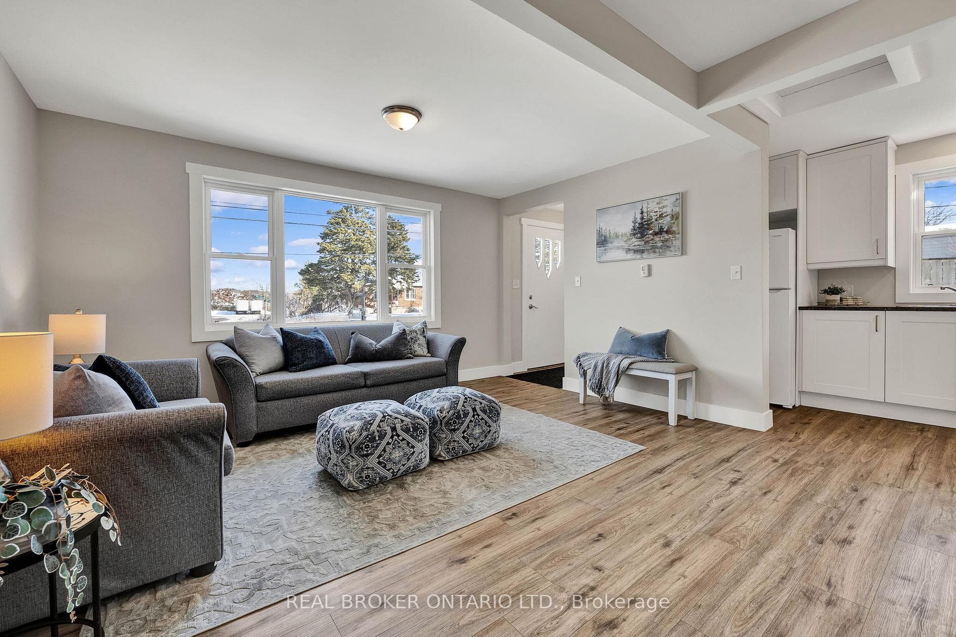Living room featuring beam ceiling, natural light