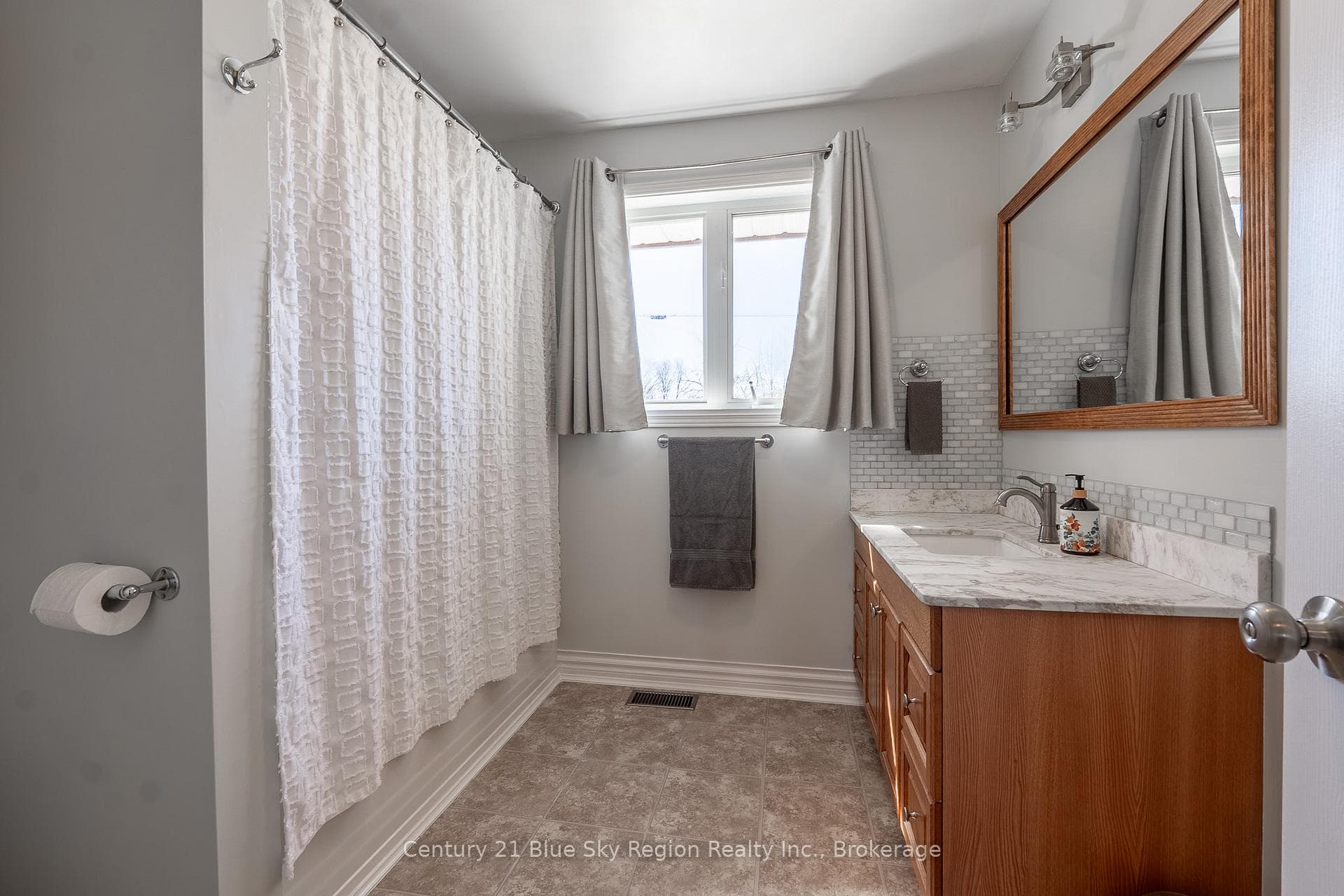 Main Floor Bath Featuring Marble Countertop