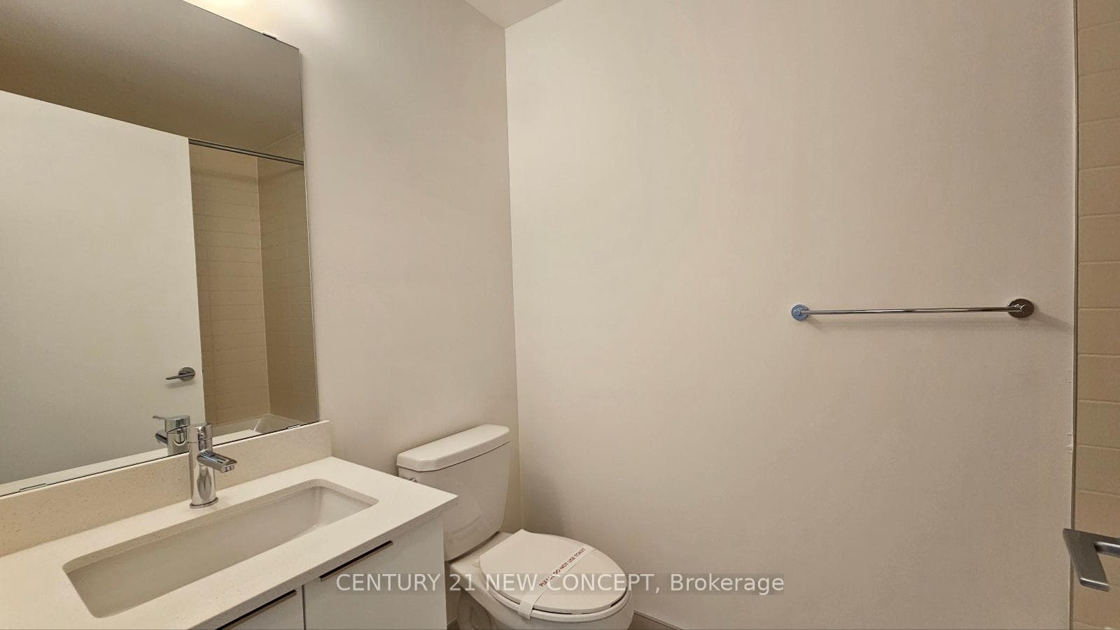 Modern vanity with wide mirror and toilet
