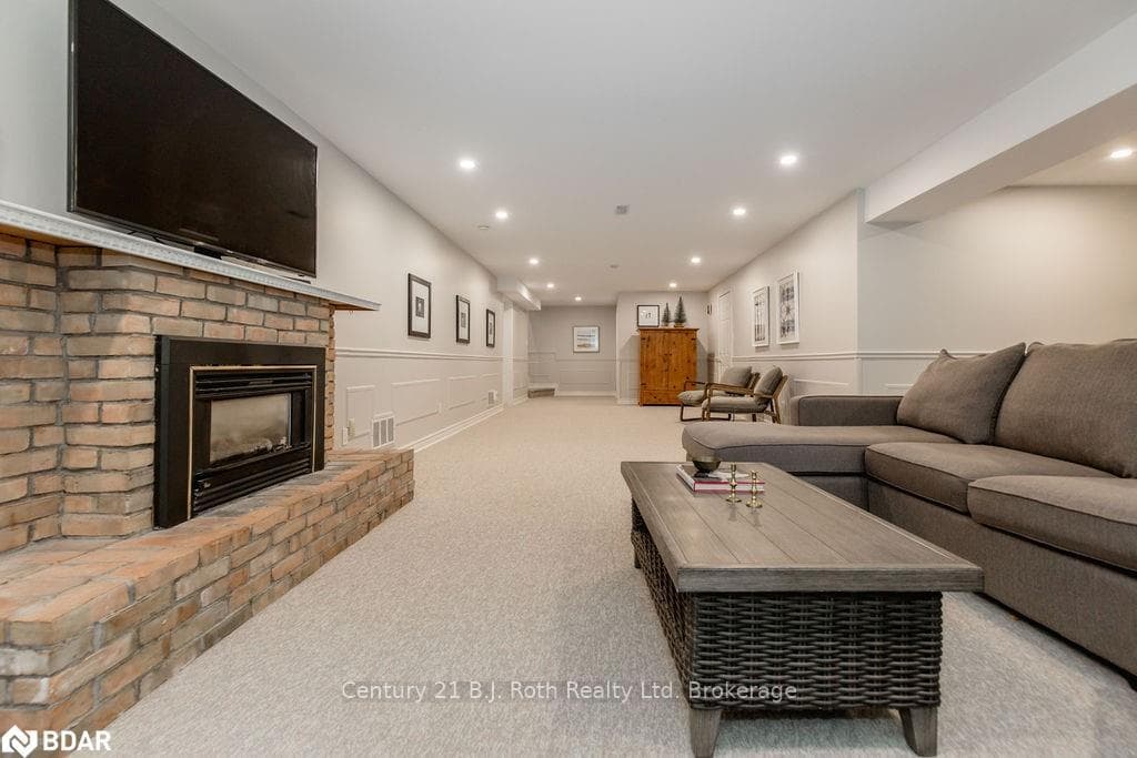 Living room with light colored carpet and a firepl