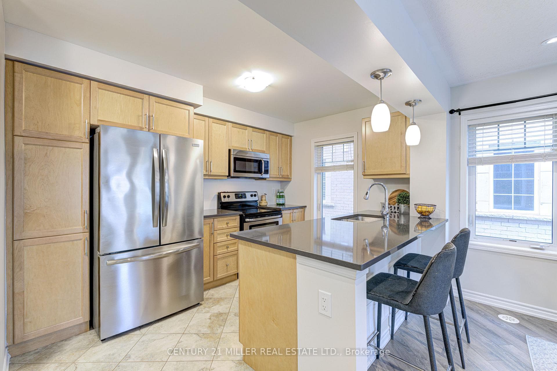 Breakfast bar, sink, and decorative light fixtures