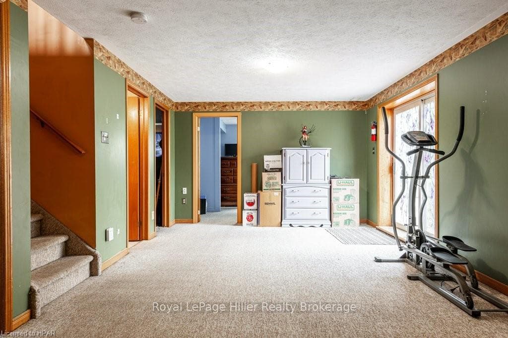 Workout room with carpet flooring and a textured c