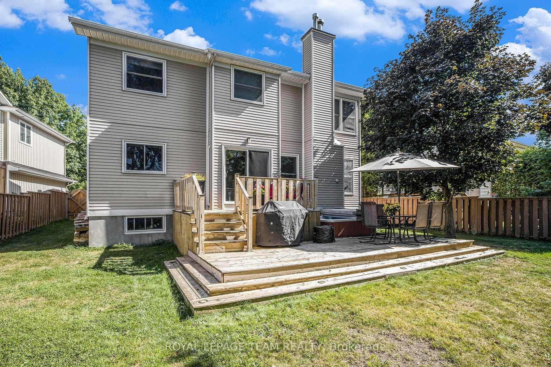 Backyard with two-tiered deck in the summer