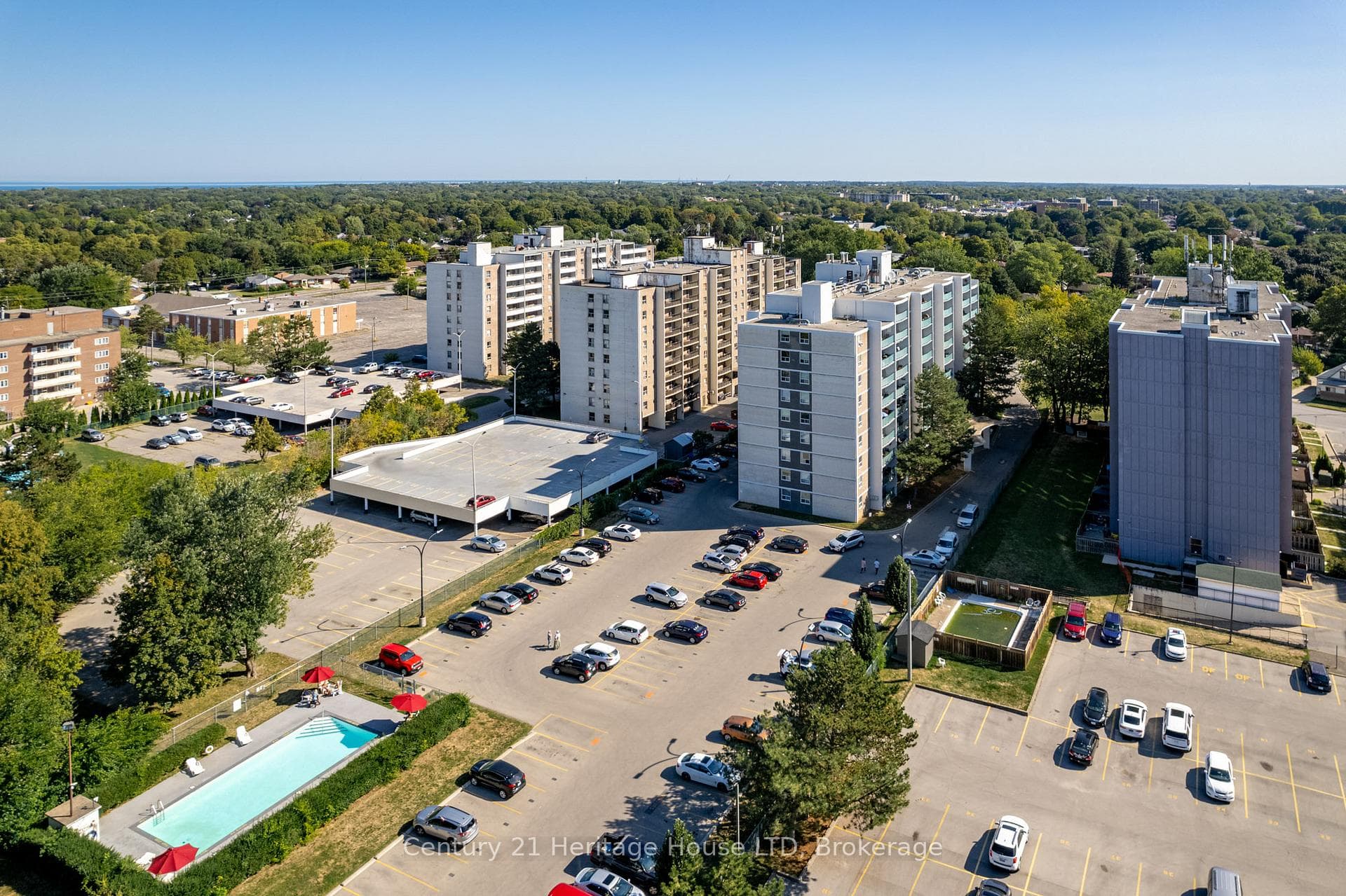 Rear of Building featuring pool, park and parking