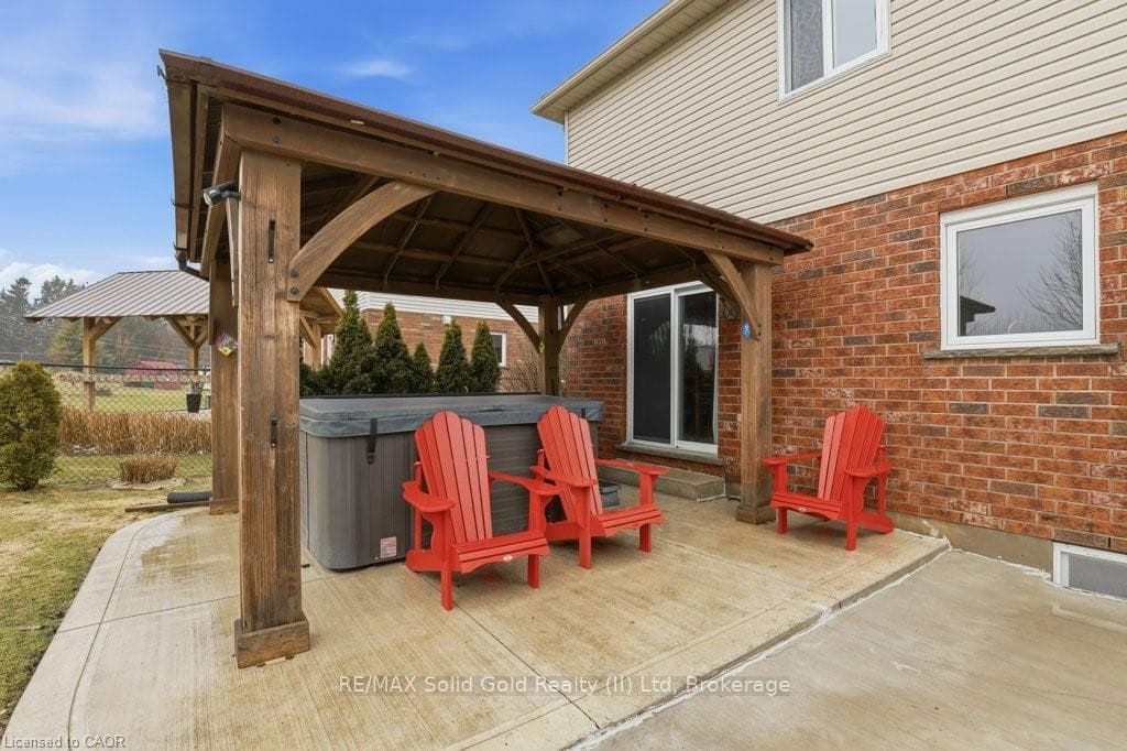 Impressive concrete patio with gazebo and hot tub