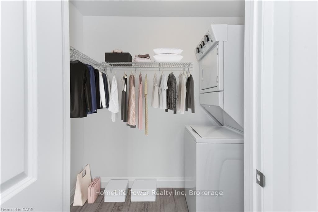 Walk-in closet with laundry (Virutally Staged)