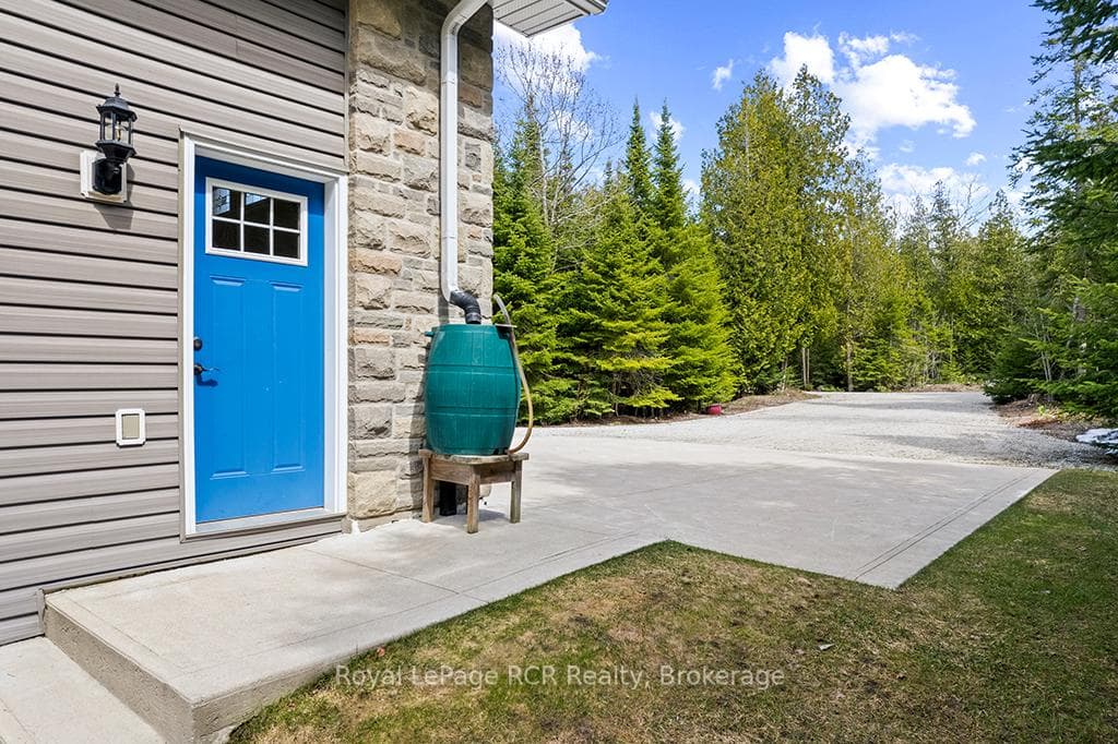 Concrete driveway in front of attached garaged.