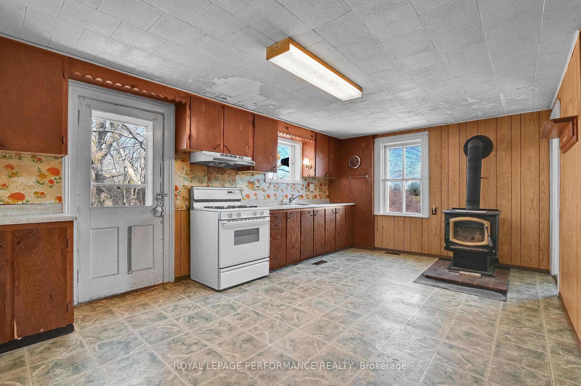 Kitchen w/wood stove & door to outside