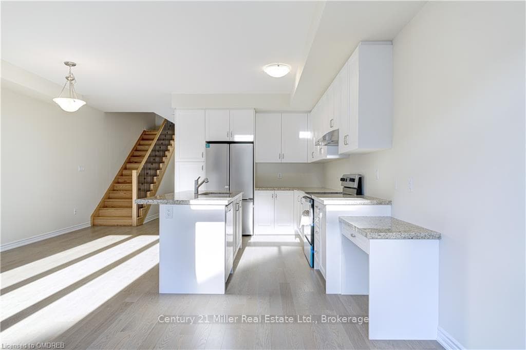 Kitchen featuring stainless steel appliances, whit