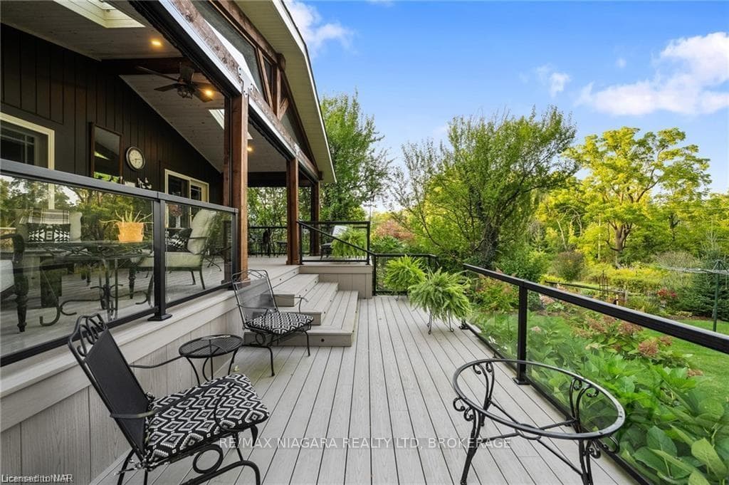 Wooden terrace featuring ceiling fan