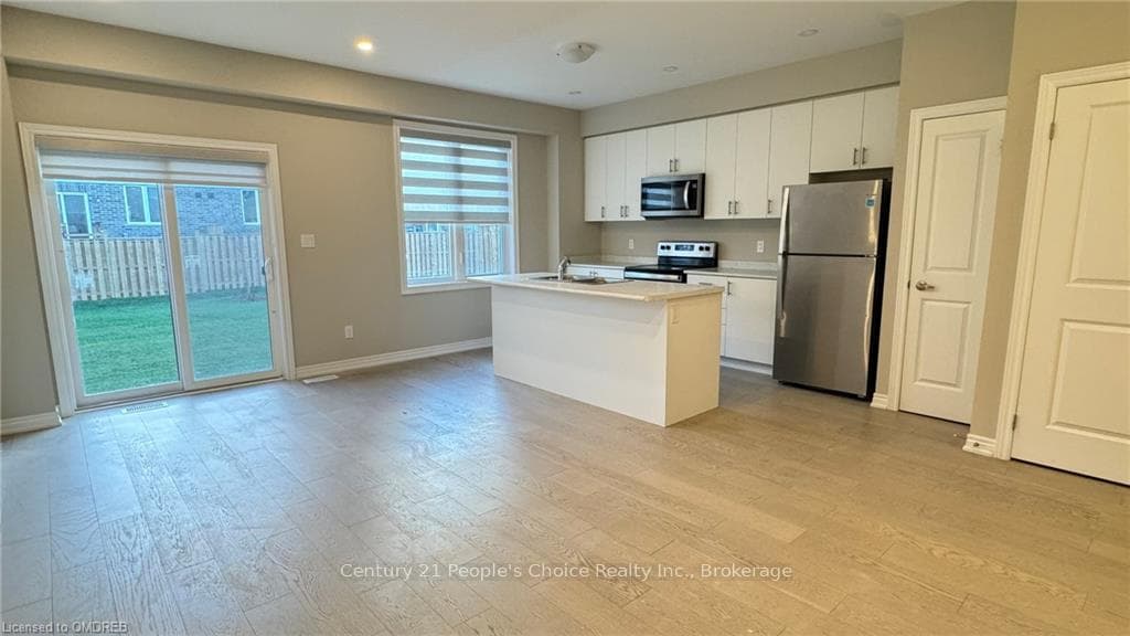 Kitchen featuring white cabinetry, an island with