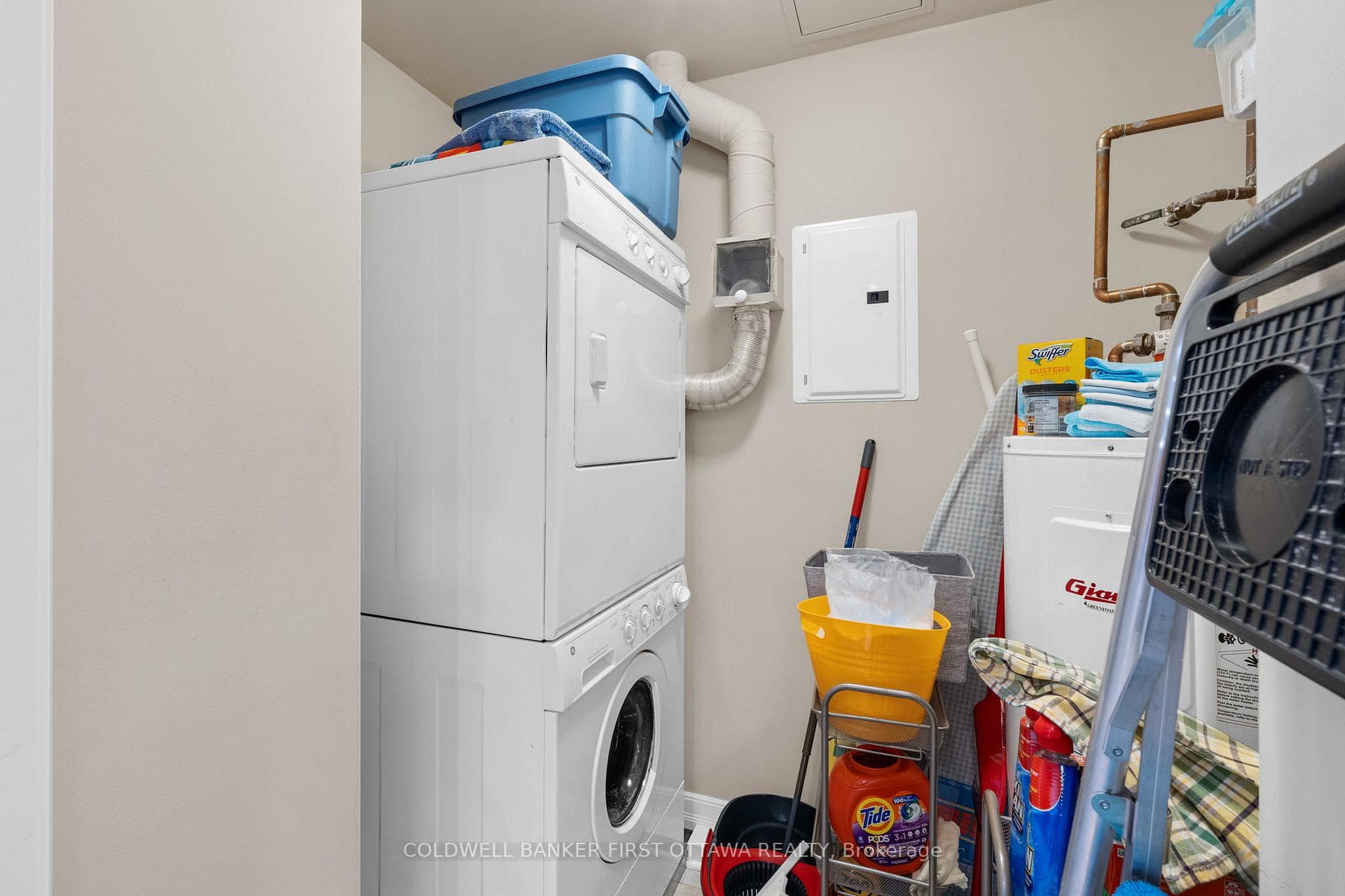Utility closet off kitchen w stacked GE - W+D.