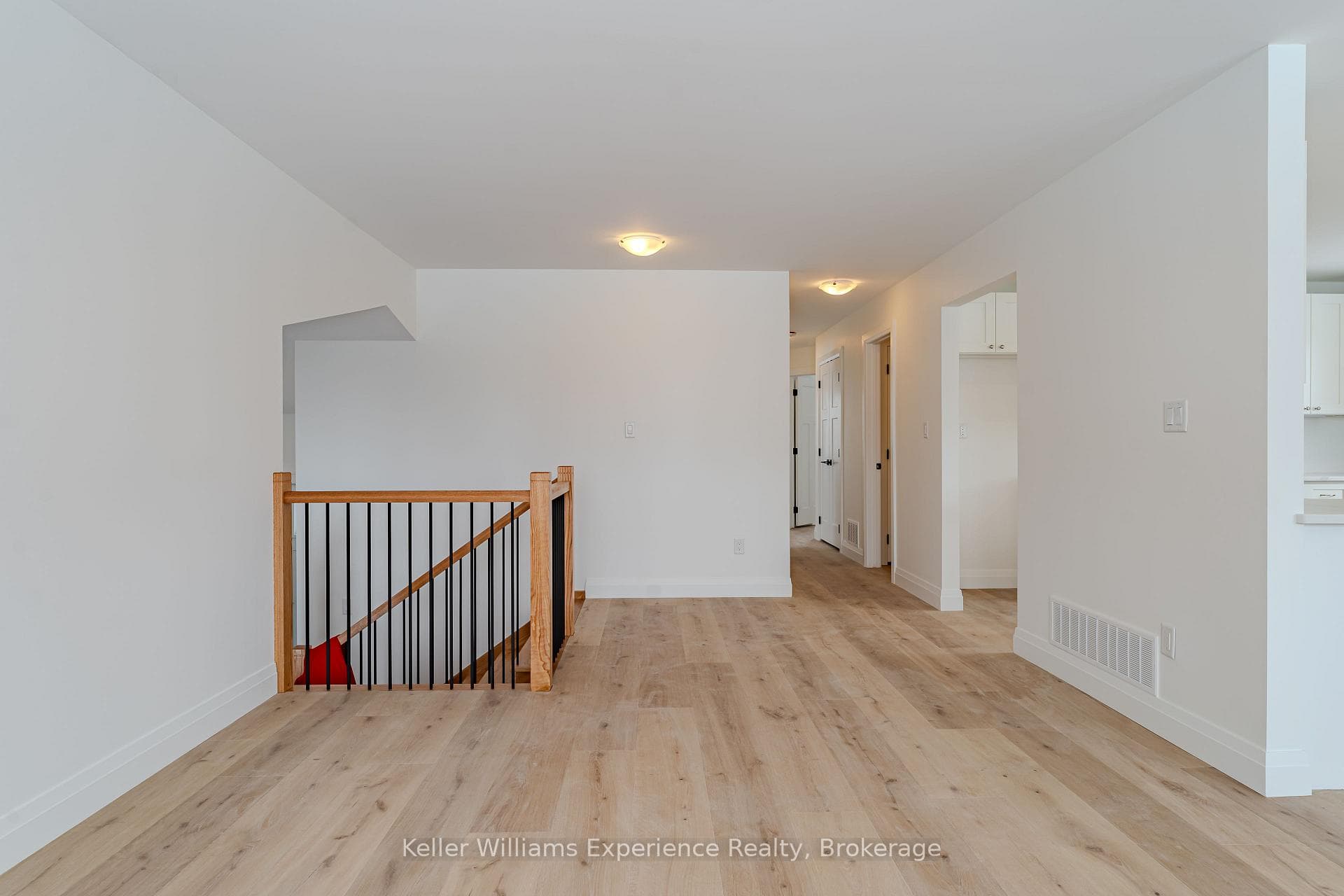 Custom Wood Rail and Sleek Black Metal Balusters