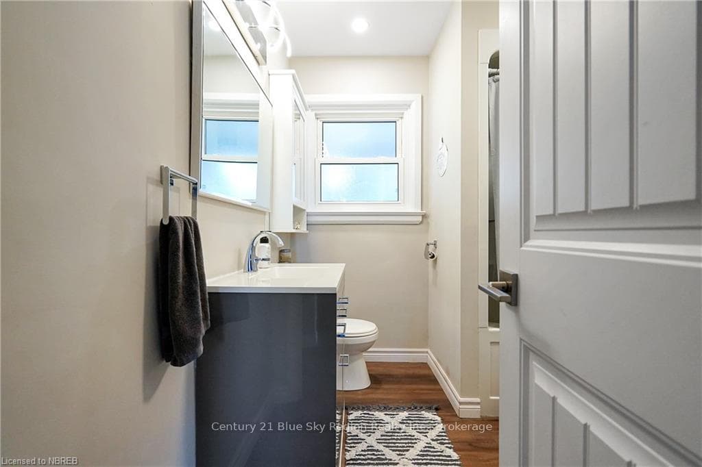 Bathroom with hardwood / wood-style floors, vanity
