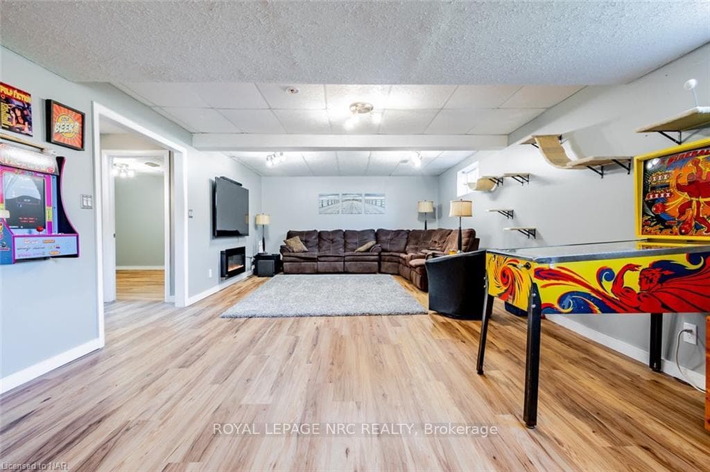 Playroom featuring a drop ceiling and light hardwo