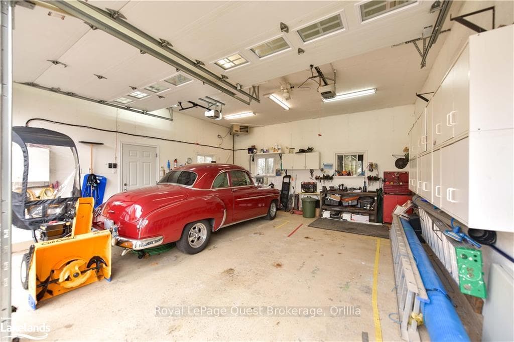 Garage with a workshop area and a garage door open