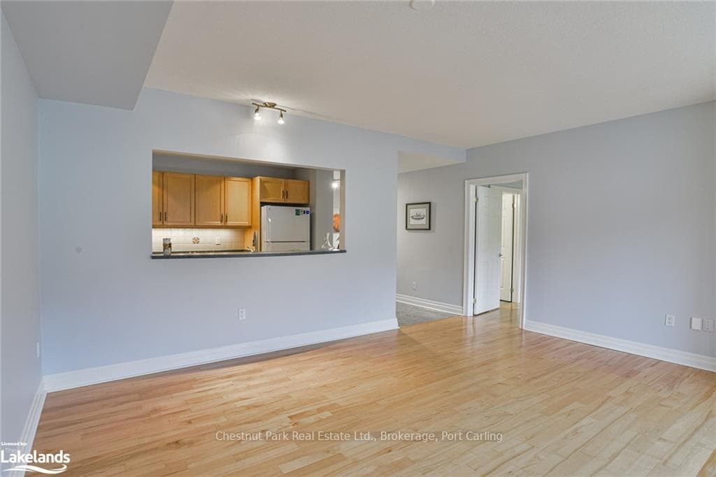 Unfurnished open-concept living room with light ha