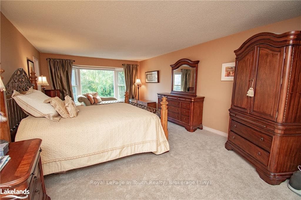 Carpeted bedroom featuring a textured ceiling