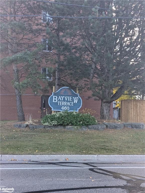 Community / neighborhood sign featuring a yard
