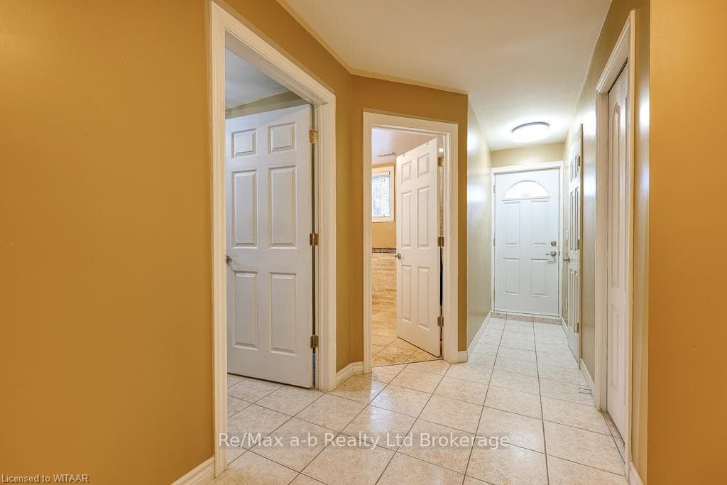 Hallway featuring light tile patterned flooring
