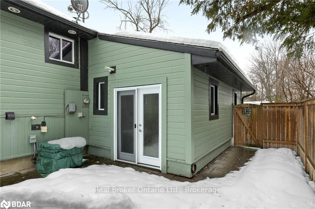 View of snowy exterior with french doors