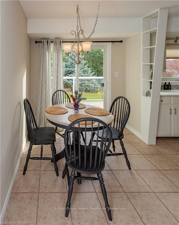 Tiled dining room with a notable chandelier and a