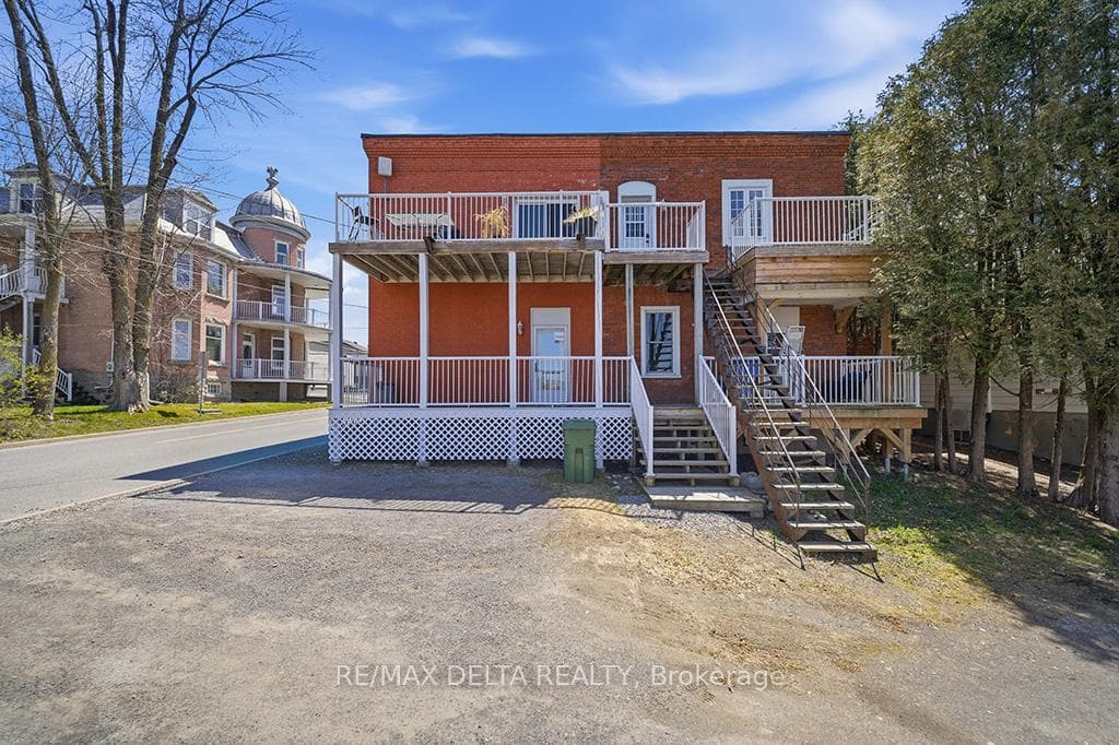 Stairs lead to upper balcony, patio door.