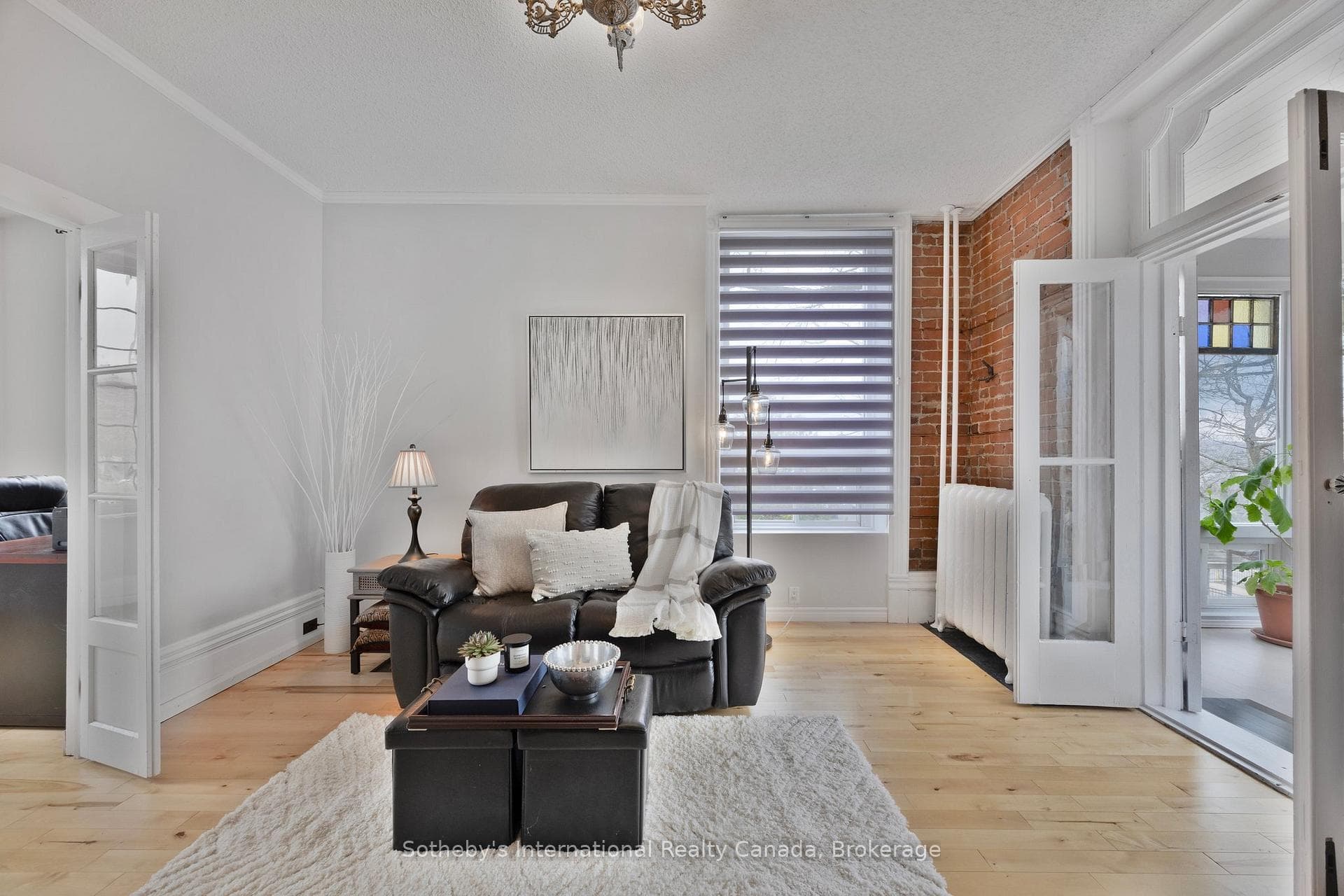 Living room open to sunroom and office/den