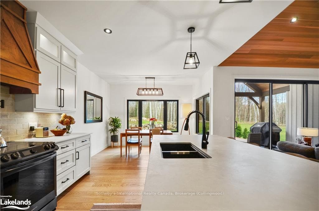 Kitchen with white cabinetry, plenty of natural li