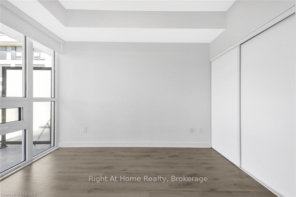 Spare room with dark hardwood / wood-style floorin
