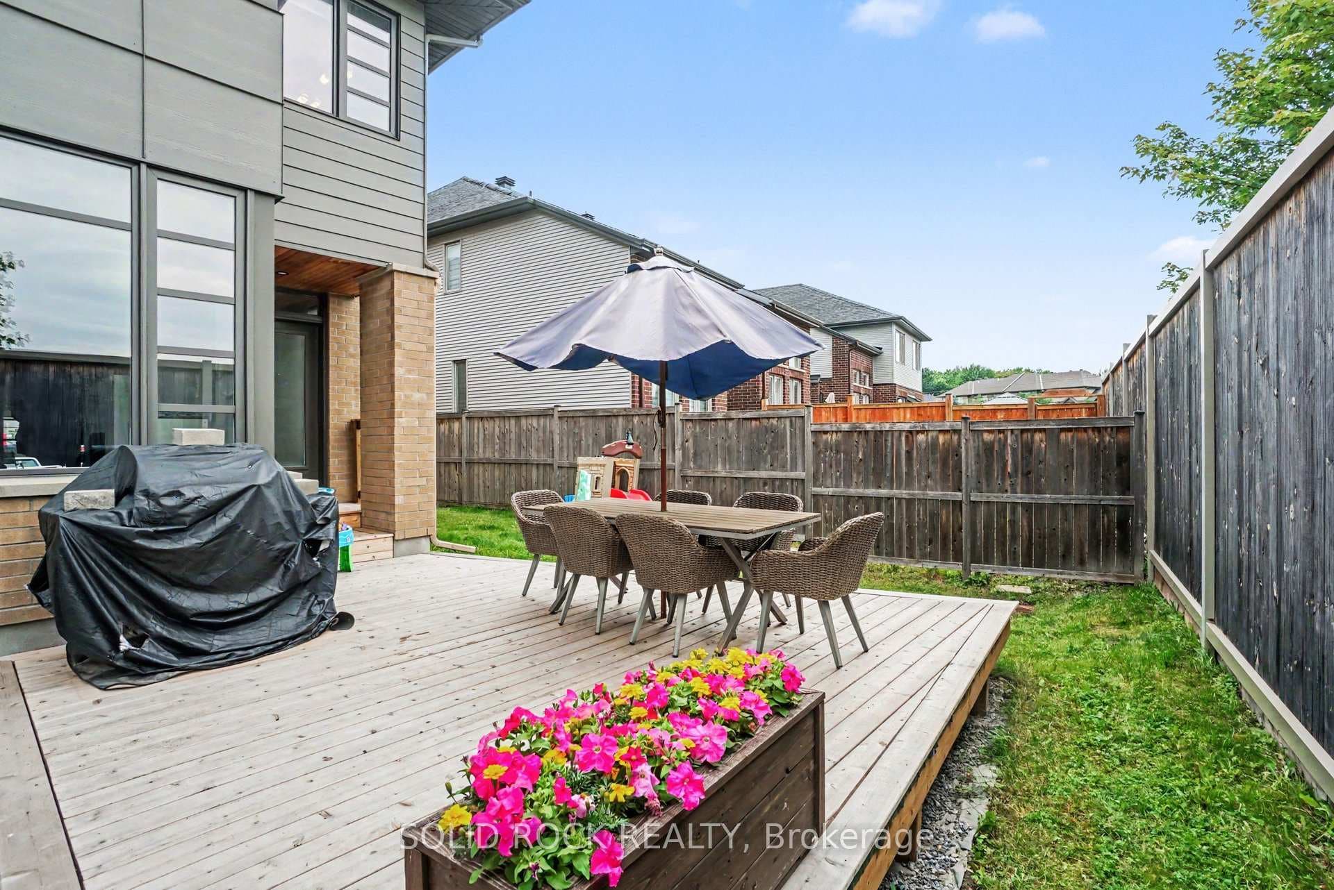Fully fenced rear yard with deck