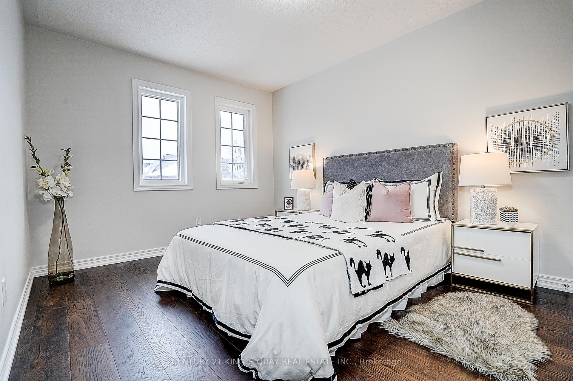 3nd bedroom with wood flooring, windows, closet