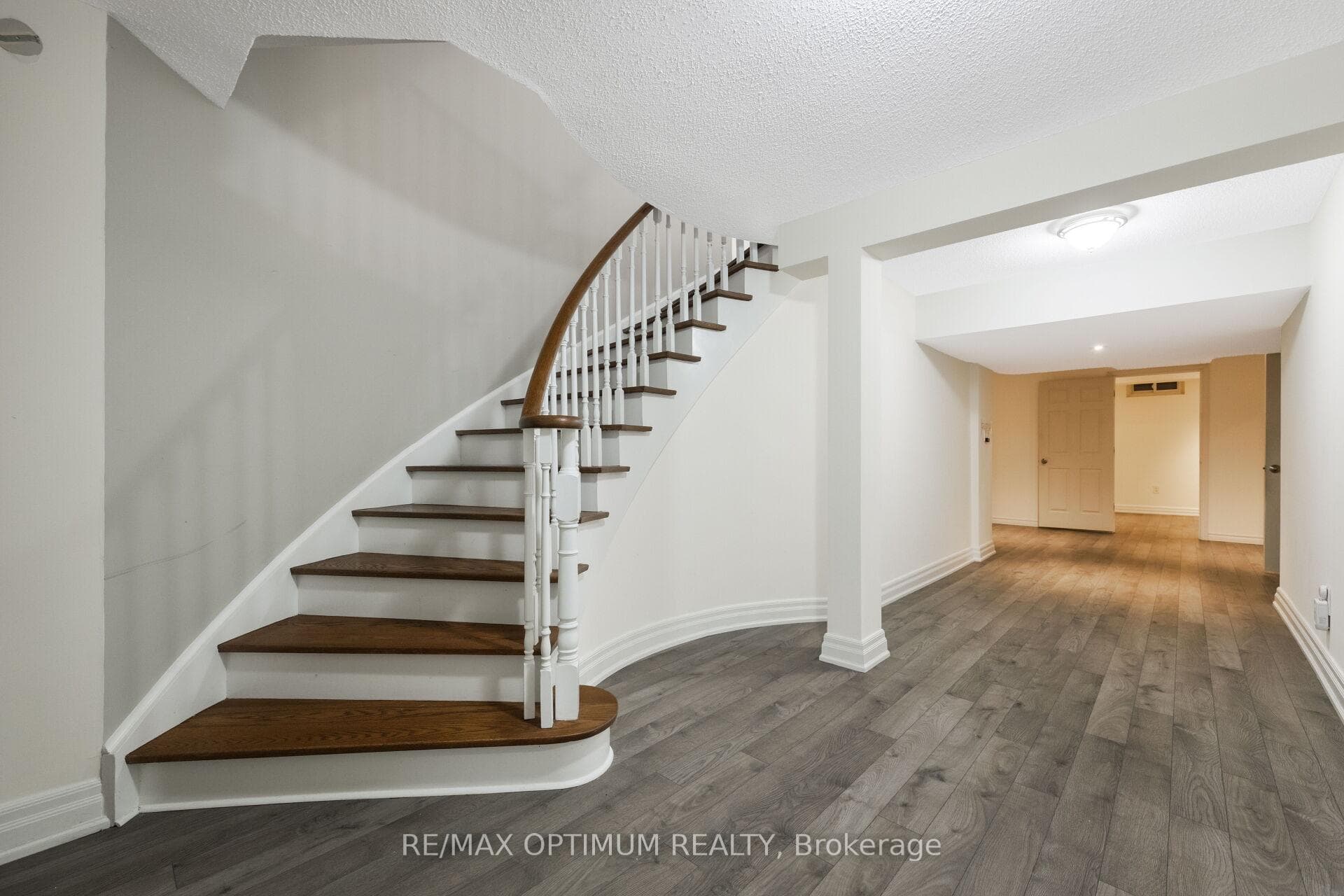 Finished basement with elegant staircase