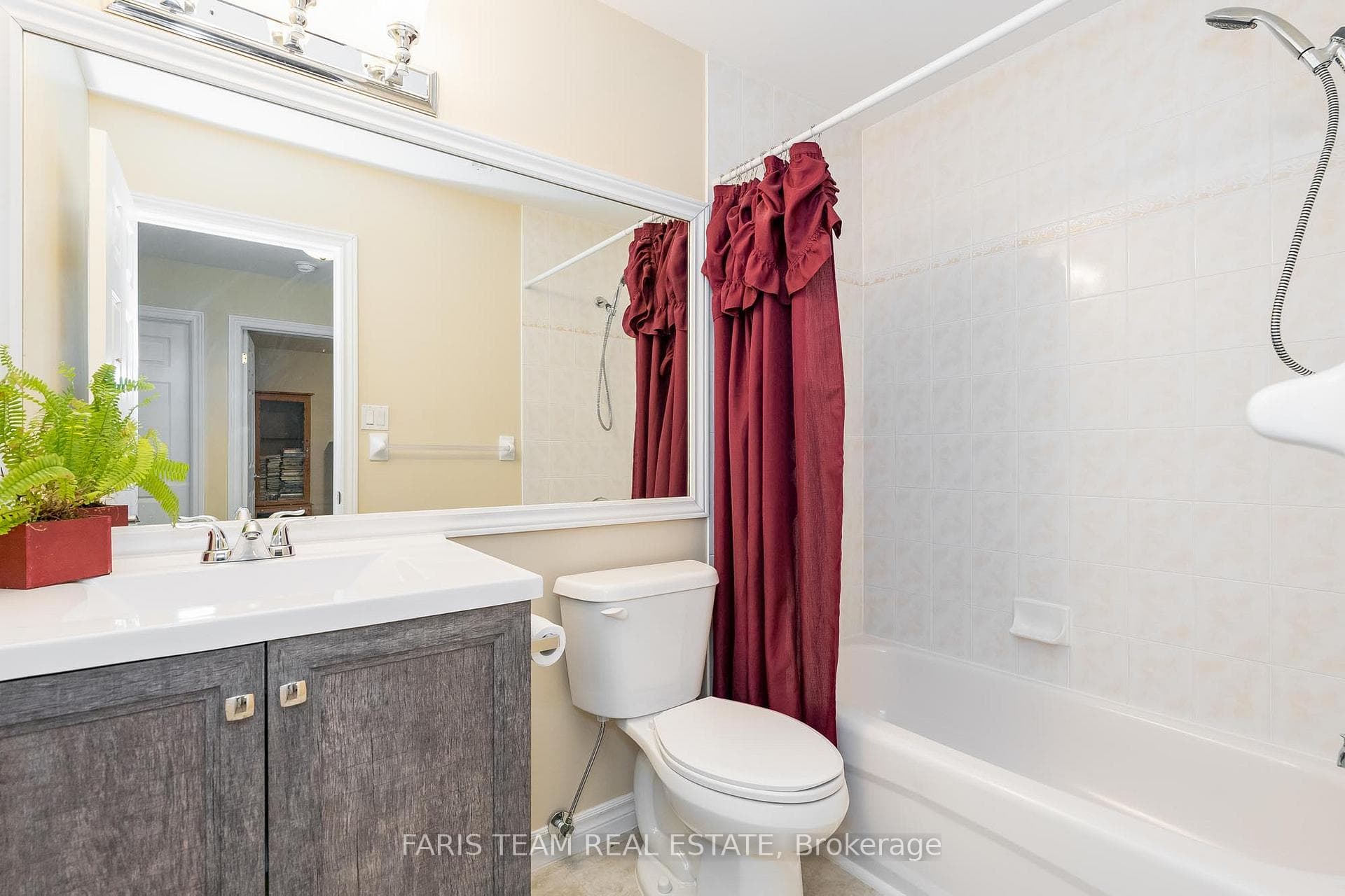 Bathroom with vanity and combined shower and bath