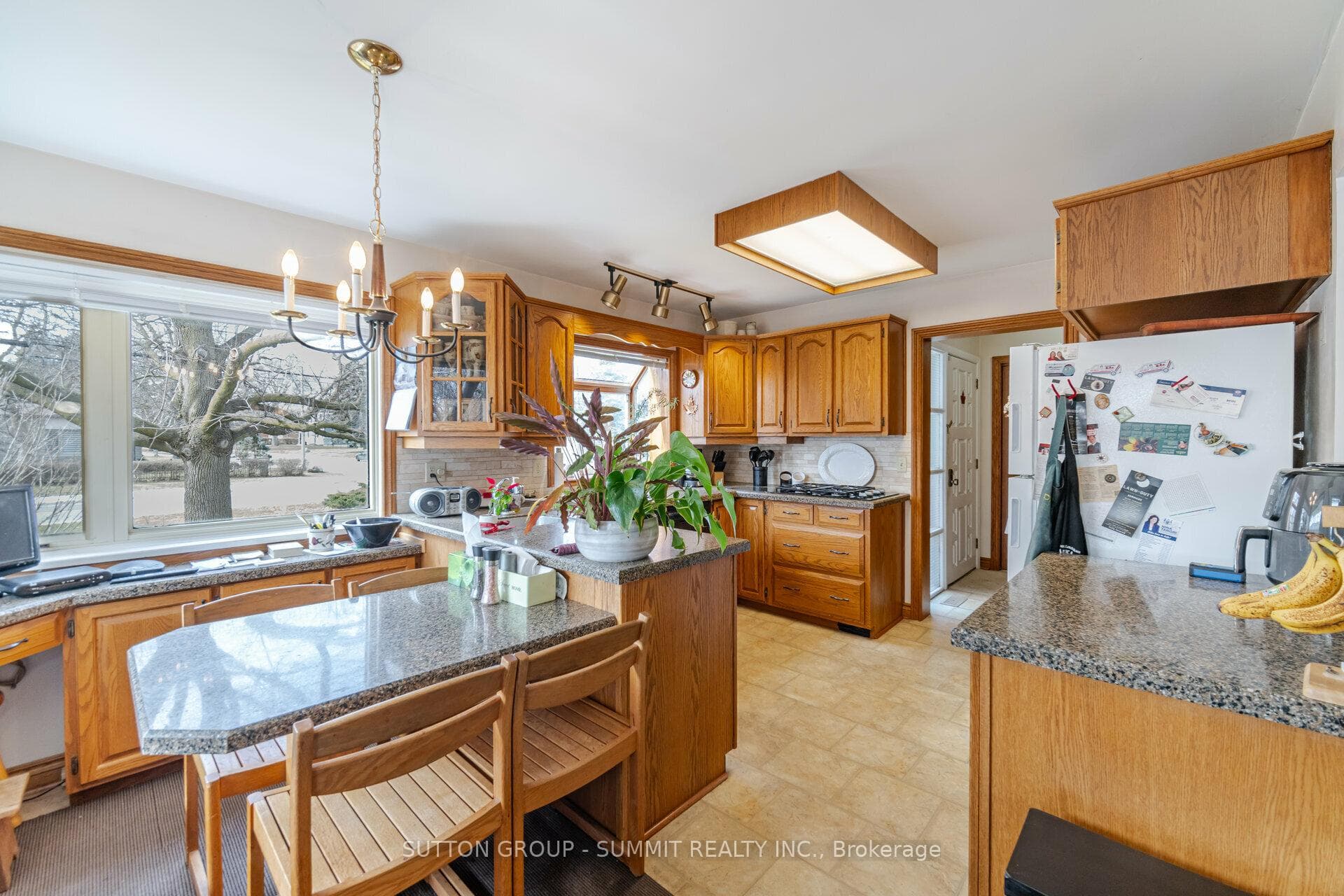 Kitchen with granite countertops & picture windows