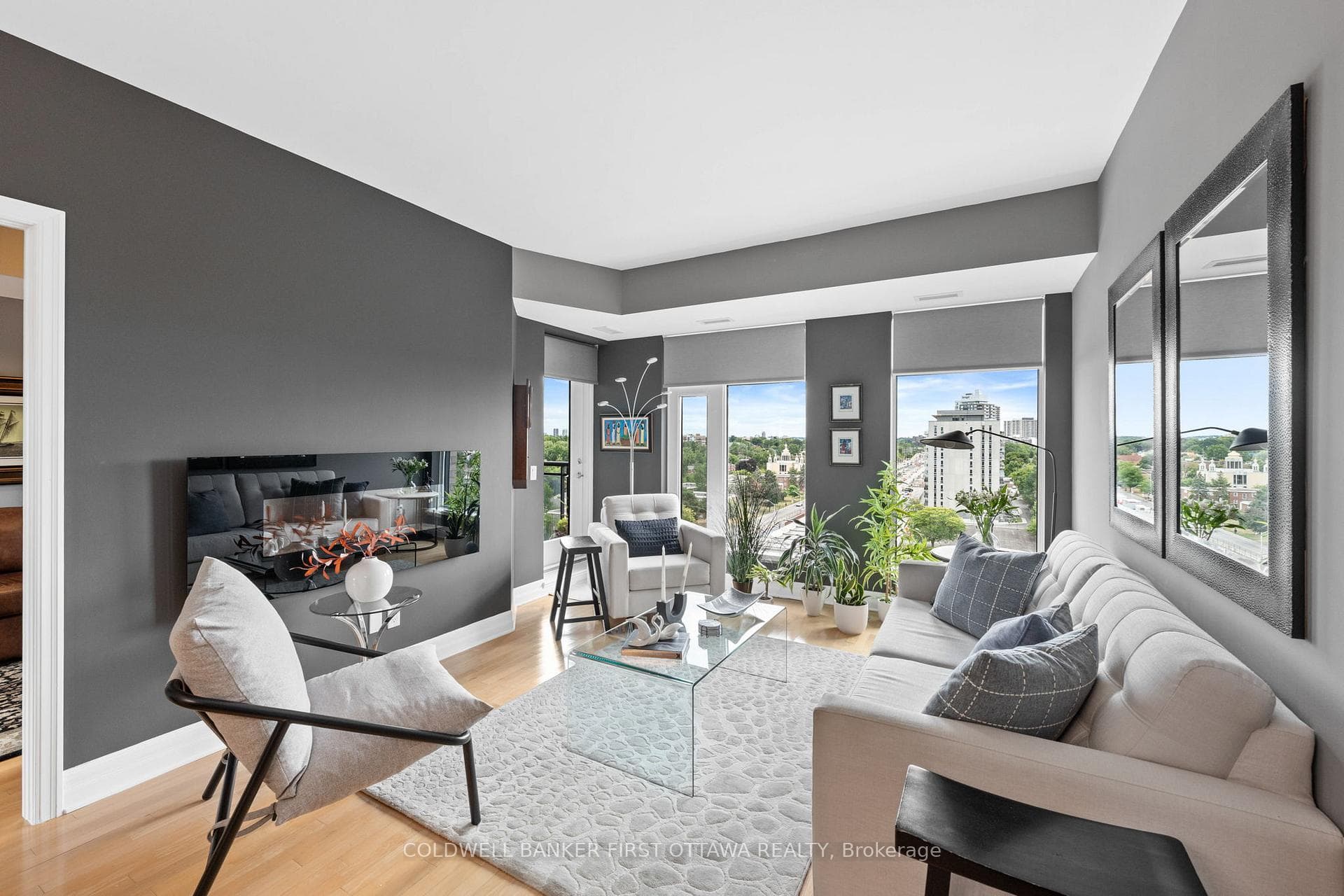 Living room w floor to ceiling windows.