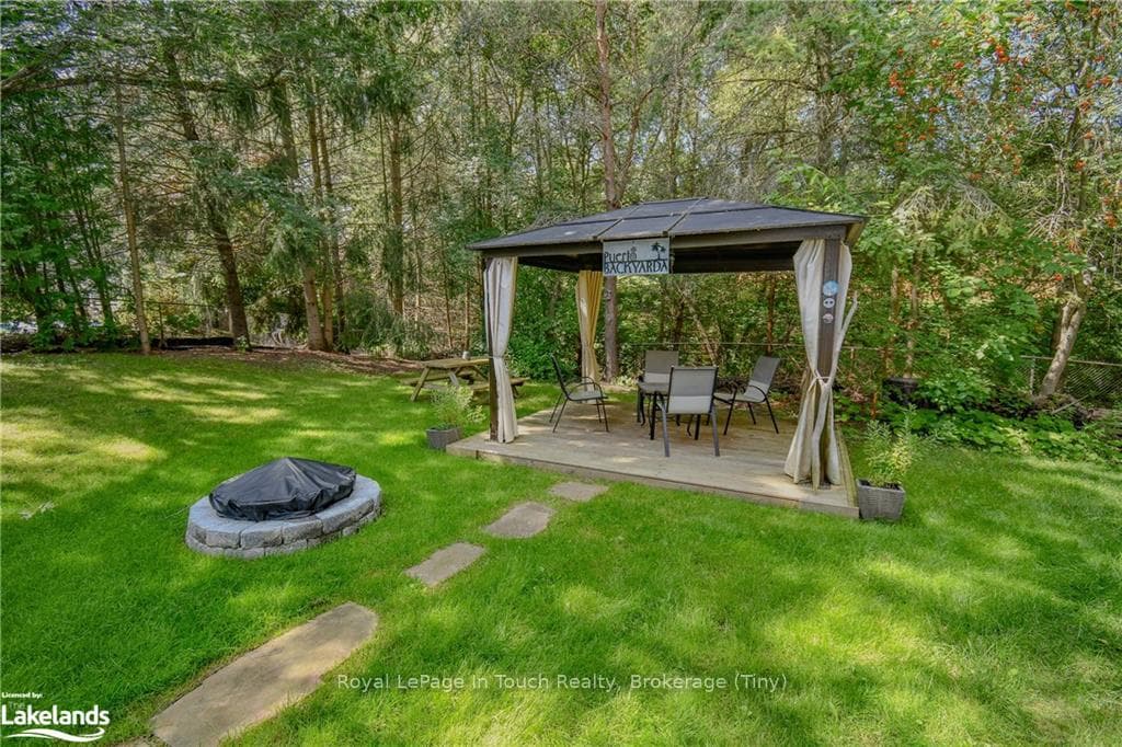 View of yard with an outdoor fire pit and a gazebo