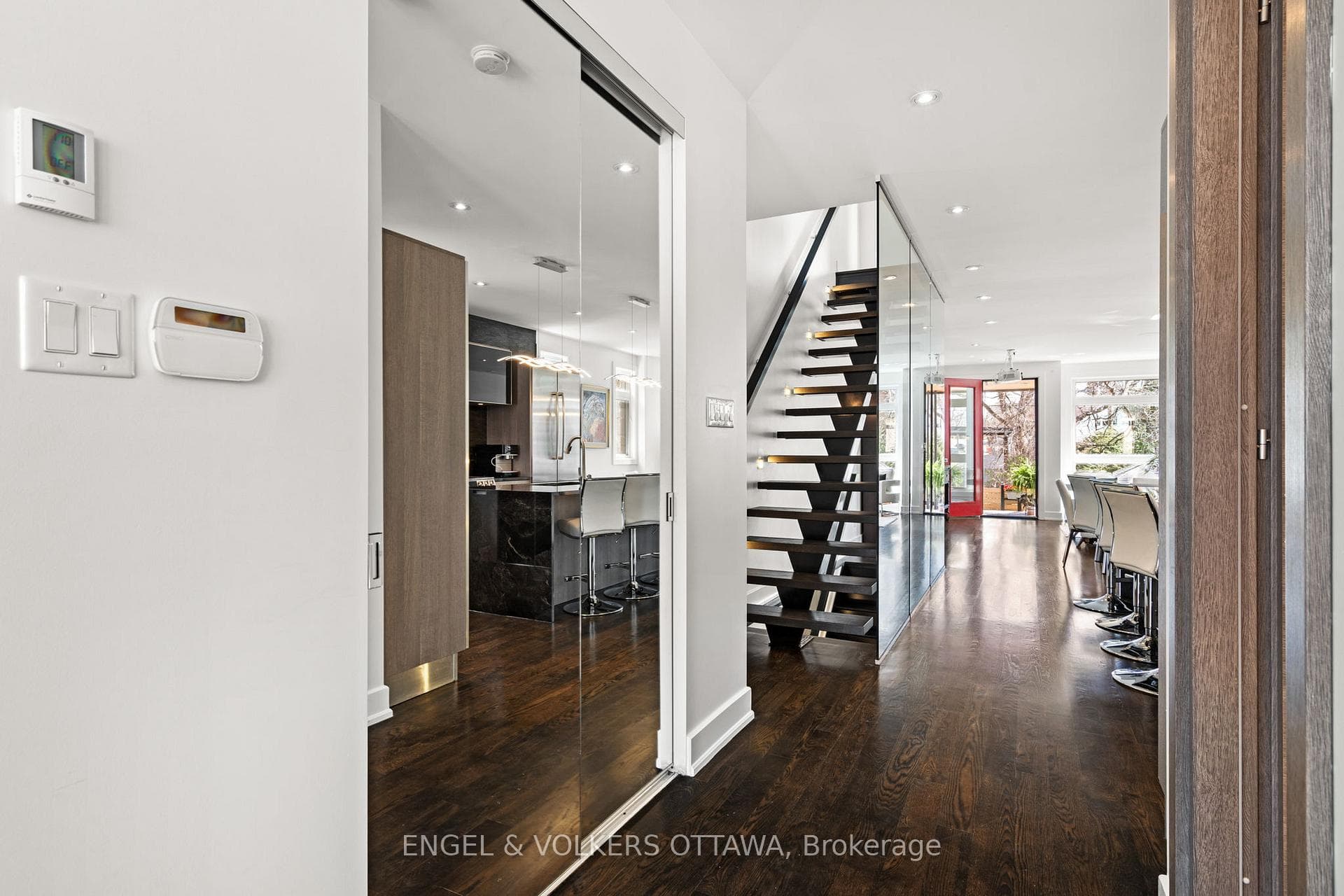 Hardwood floor & stylish glass staircases thruout