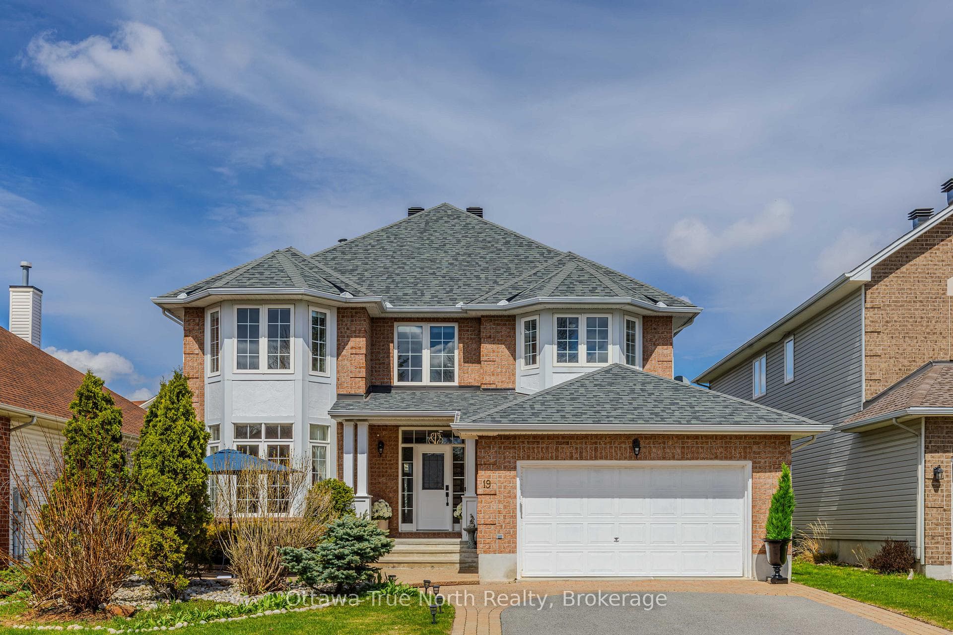 Great Curb appeal with red brick & landscaping.
