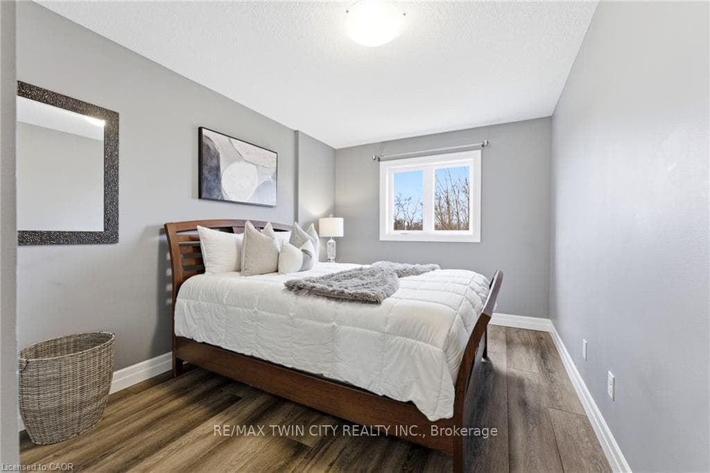 Second bedroom with luxury vinyl plank flooring.