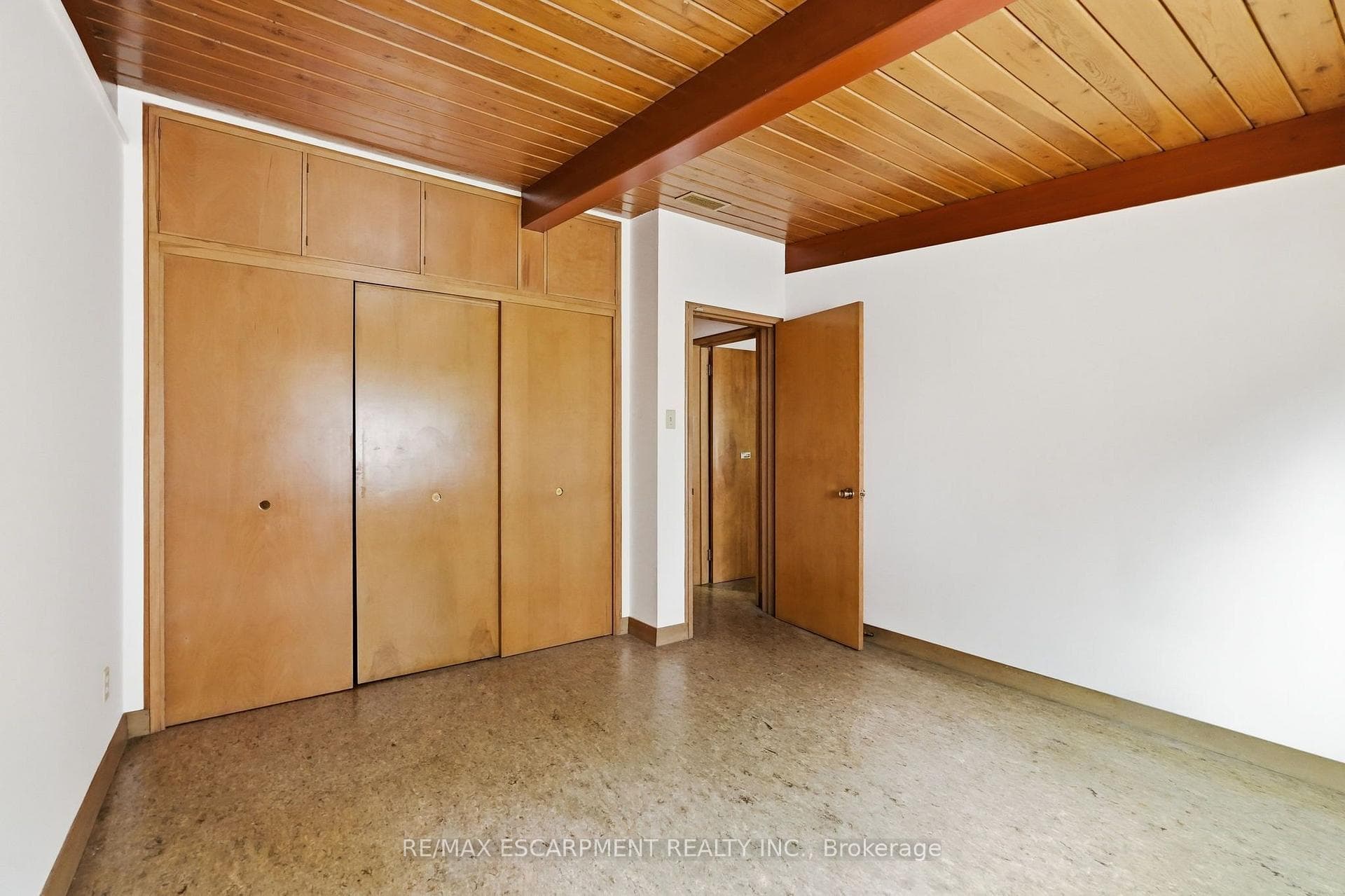 Exposed beams, wood-finish built-in cabinetry