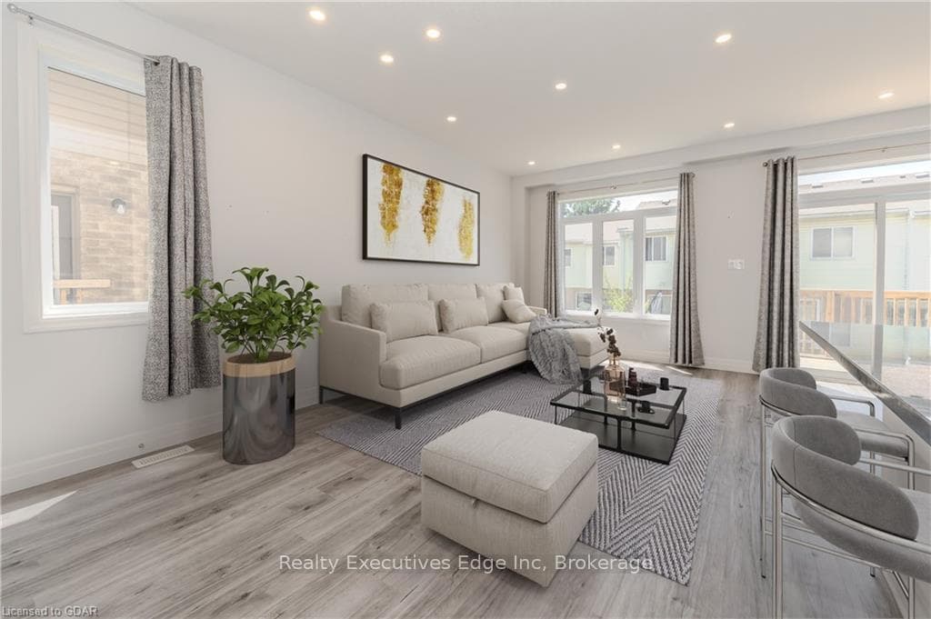 Living room with light hardwood / wood-style floor