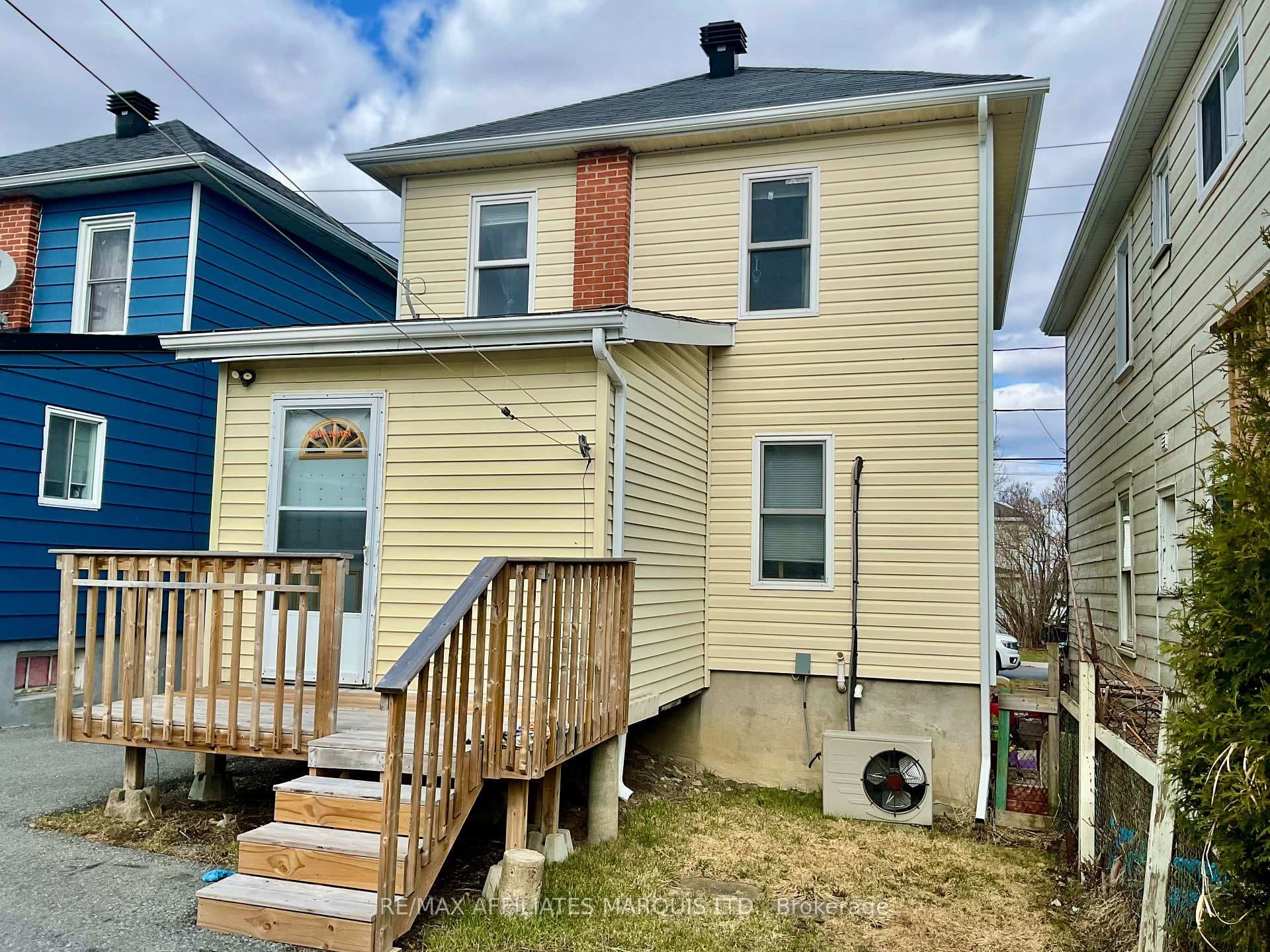 Back of house with enclosed porch & deck