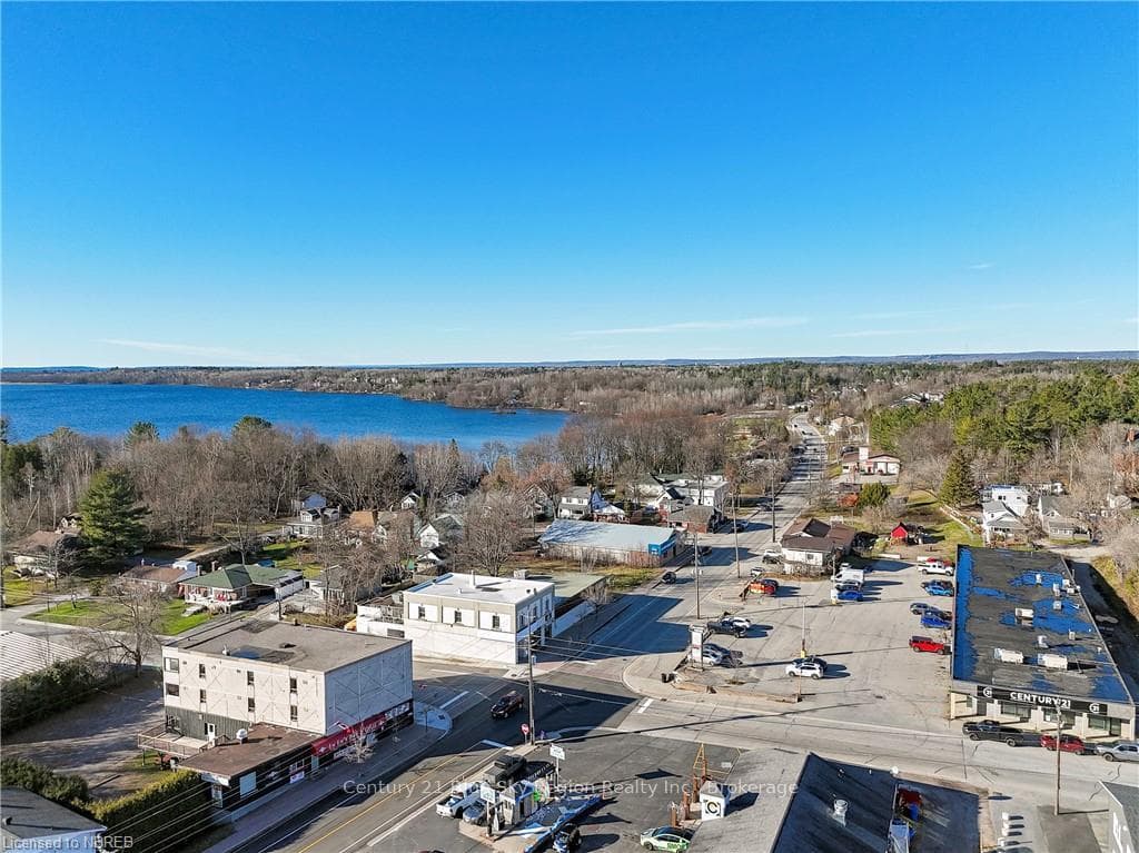 Birds eye view of property with a water view